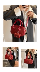 Close-up of red woven texture pillow bag with detachable strap and mini pouch pendant