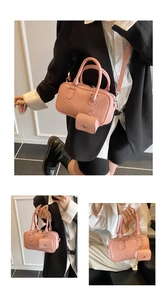 Detail of pink faux crocodile leather Boston bag with matching mini pouch and top handles