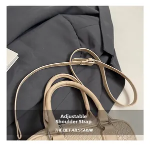 Detail showing the adjustable shoulder strap and woven texture of the beige Boston handbag