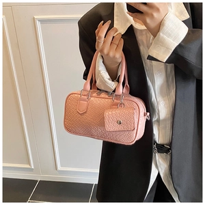 Detail of pink woven texture Boston bag with detachable mini pouch and silver hardware