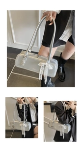 Silver metallic baguette shoulder bag with white lace bow and chic pendant for women fashion.