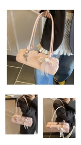 Chic pink patent leather baguette shoulder bag with cute lace bow and heart metal charms.