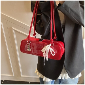 Red patent leather baguette shoulder bag featuring a white lace bow and cute heart charm.