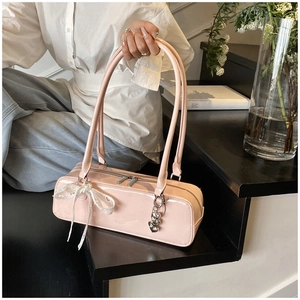 Pink patent leather baguette shoulder bag, chic elegant underarm handbag with bow charm for women.