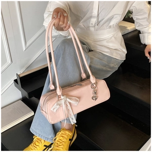 Pink patent leather baguette shoulder bag with cute lace bow and heart pendant for women.