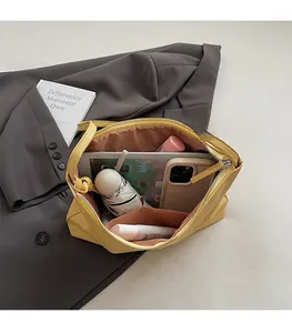 Top view of large yellow leather tote bag interior showing ample storage for daily essentials