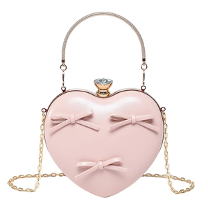 Pink heart-shaped evening bag with bow accents, crystal clasp and metal handle