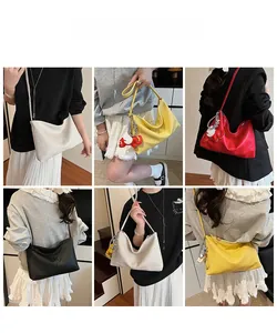 Detail shots of large hobo bag with pleated texture and charms in multiple colors