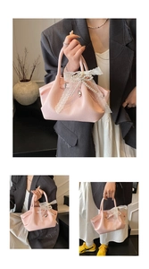 Detail of pink lychee grain PU handbag with lace bow and pearl heart charm