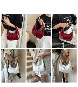 Chic patent leather crescent handbag in red and white colors shown in various poses