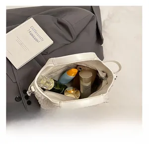 Vue du dessus de l'intérieur du sac seau blanc montrant l'espace pour maquillage et mobile