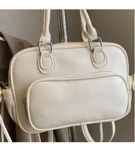 Detail of light beige Boston bag showing lychee grain texture and front zipper pocket