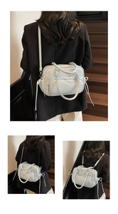 Detail of mint green lychee grain leather bag showing versatile straps and texture