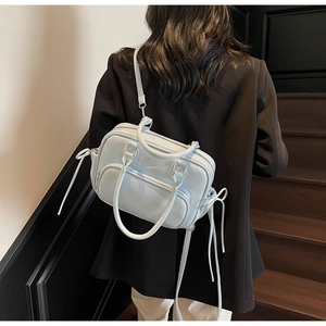 Detailed view of light blue backpack with bow accents and pebble leather texture