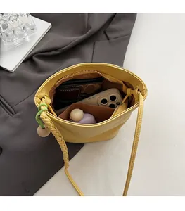 Top view of yellow bucket bag interior showing spacious capacity for phone and wallet