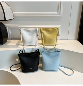 Detailed collection of leather bucket bags in white, yellow, black and blue with woven handles