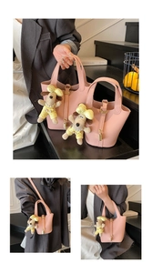 Pink lychee grain bucket bag with metal lock and cute puppy plush pendant detail
