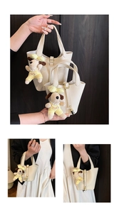Detail view of lychee pattern leather bucket bags in two sizes with dog charm