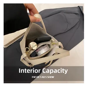 Detail view of large interior capacity of lychee grain bucket bag with essentials