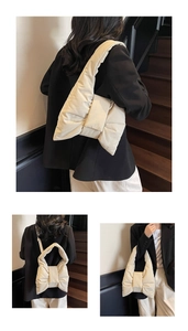 Detail of a beige puffy ribbon tote bag with soft quilted texture and bow design