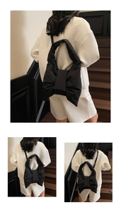 Detail view of a black puffed bow backpack with soft nylon fabric and adjustable straps