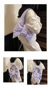Detailed view of lavender padded bow shoulder bag with quilted nylon texture and puffy design
