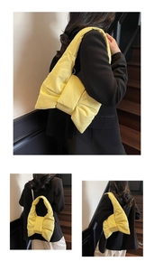 Detail of a bright yellow quilted bow tote bag with soft padded texture and wide handle