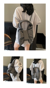 Close-up of padded bow shoulder bag in dark grey with puffy down-like texture and details