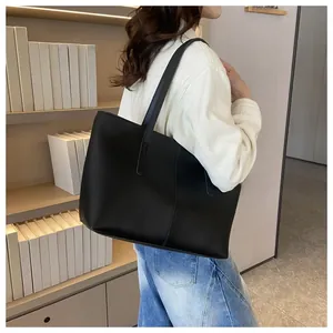 Detail view of a black large capacity tote bag with vertical stitching for office use