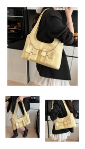 Detail of cream faux leather tote bag with functional double pockets and silver chains