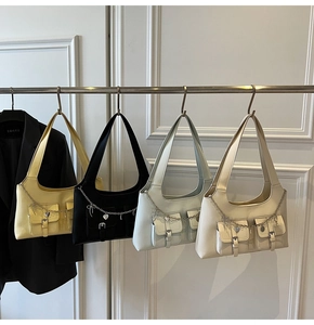 Close-up of four colors of Y2K vintage style faux leather tote bags with metal chains