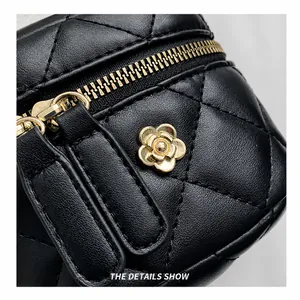 Macro shot of black quilted leather bag with gold floral hardware and premium zipper
