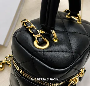 Close-up of quilted leather handbag featuring gold metal eyelets and woven chain strap