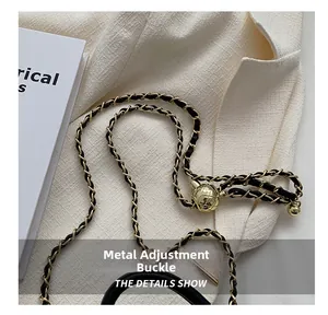 Detail of gold metal ball adjustment buckle and quilted chain strap on mini bag