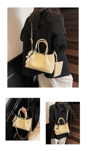 Detail of cream woven tote bag with daisy charm, matching pouch and adjustable strap