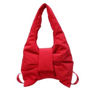 Quilted nylon bow-shaped tote bag in vibrant red, stylish puffy aesthetic design