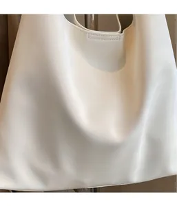 Detailed close-up of soft white fabric texture on a minimalist large tote bag