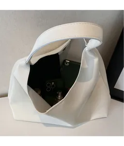 Interior view showing the spacious capacity of this minimalist white leather tote bag