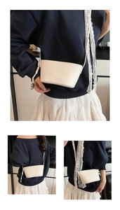 Detail view of large-capacity lychee leather bucket bag showing side and back textures