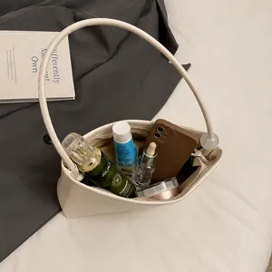 Interior storage capacity of the cream baguette bag showing daily essentials