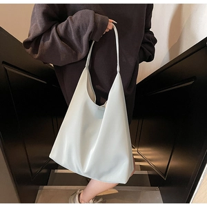 Detailed view of grey large capacity tote bag showing smooth faux leather texture