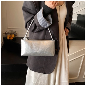 Silver metallic rectangular handbag with crinkled texture and white bead charm detail
