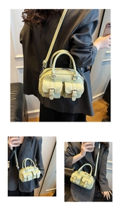 Détail du sac Boston en cuir ciré vert clair avec poches à boucles et bandoulière amovible