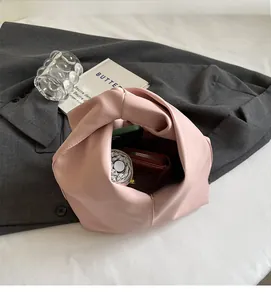 Pink pleated leather handbag interior showing large storage capacity and inner space