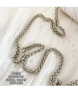Close-up of durable silver metal chain strap with intricate woven texture for handbags
