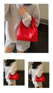 Detail of red slouchy cloud bag showing soft leather pleats and vertical stitching details