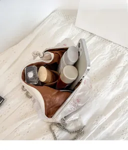 Interior view of white embroidered floral crossbody bag showing spacious storage capacity