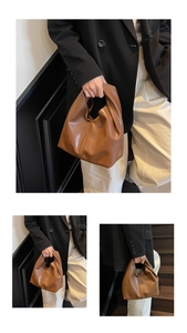 Detail of a soft brown leather handbag showing side profile and flexible texture