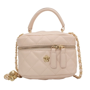 Mini quilted box bag in light pink faux leather with gold floral detail and chain strap