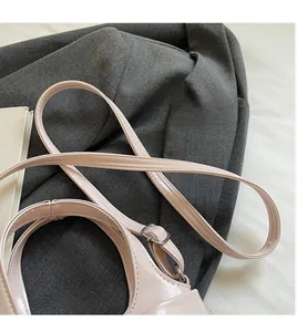 Détail de la bandoulière réglable en cuir rose brillant avec boucle en métal argenté